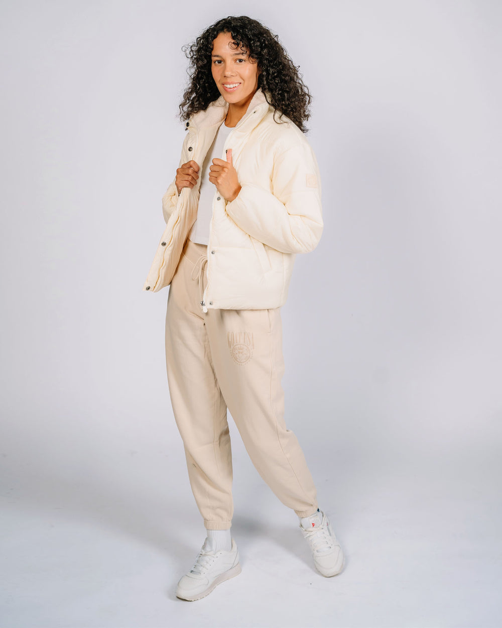 Female model wearing ivory puffer jacket#color_ivory