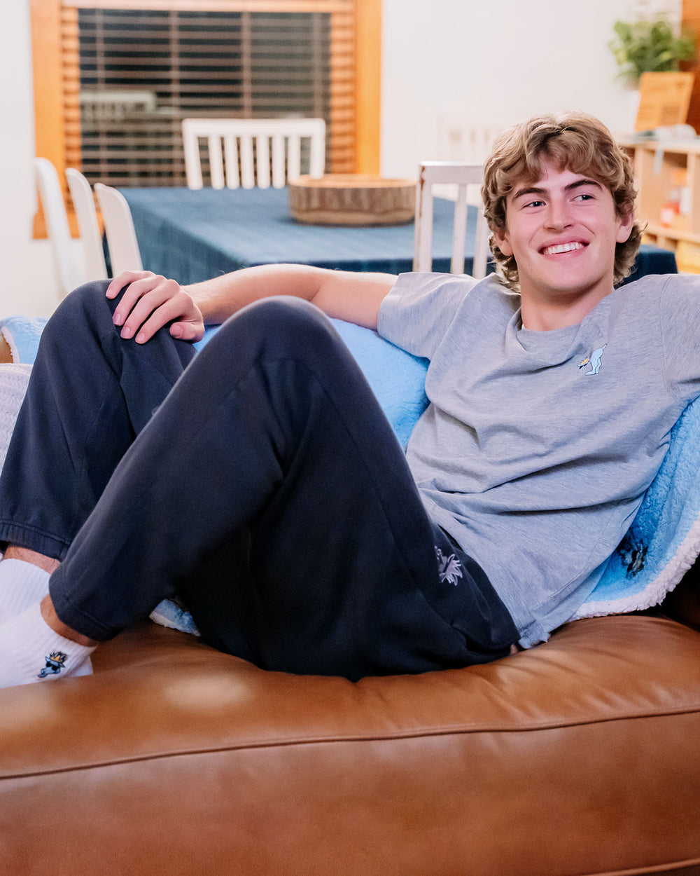 Male model sitting on a couch#color_black