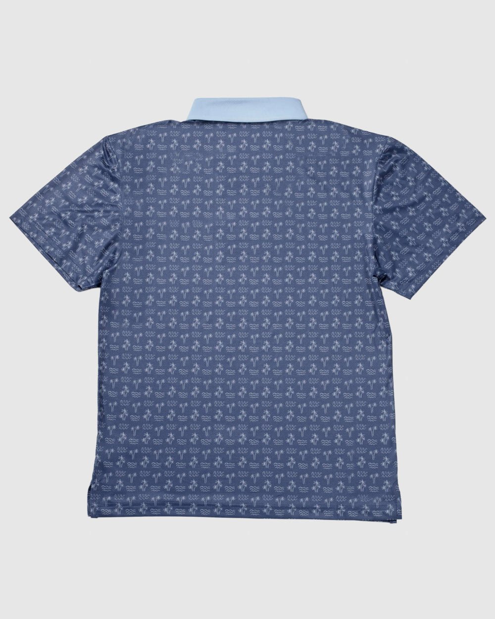 Back of navy colored polo with palm tree pattern